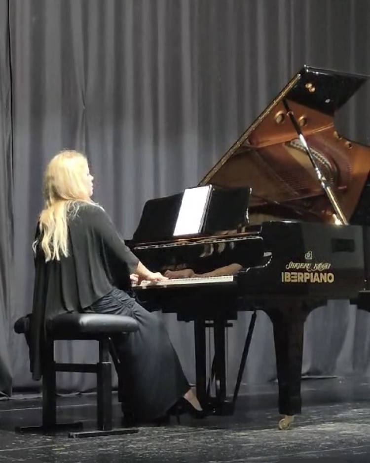 Audio/Video, Dena Kay Jones performing on a piano labeled 
